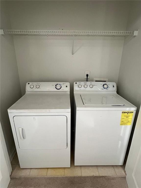 washroom featuring light tile patterned floors and washer and dryer