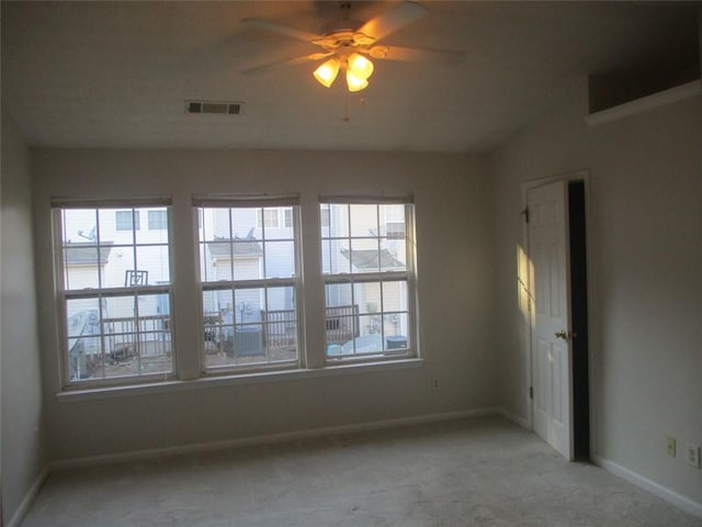 spare room with carpet floors and ceiling fan