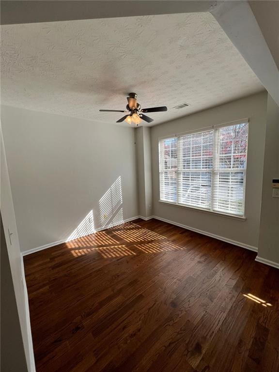 interior space featuring ceiling fan, a textured ceiling, and dark hardwood / wood-style floors