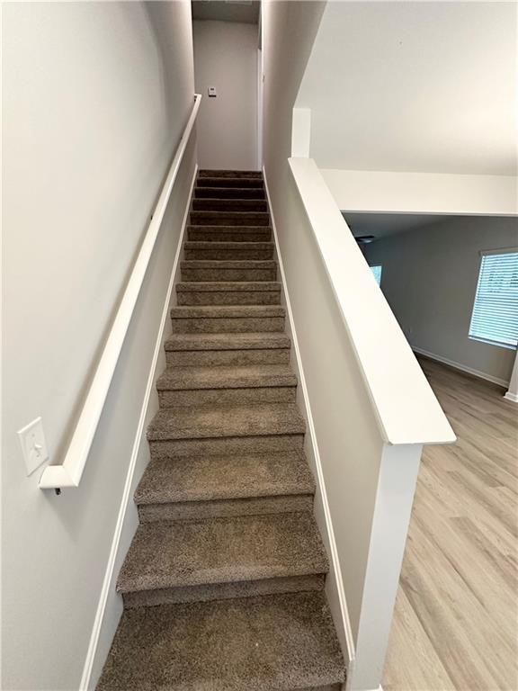 836 Courthouse Park Dr, Temple, GA 30179 - staircase with wood finished floors and baseboards