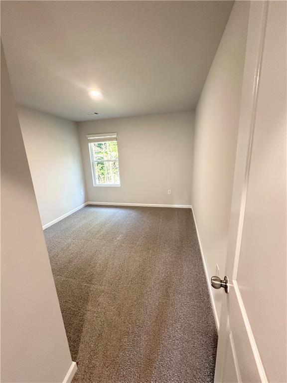 836 Courthouse Park Dr, Temple, GA 30179 - unfurnished room featuring baseboards and carpet