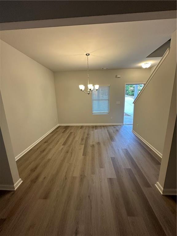 836 Courthouse Park Dr, Temple, GA 30179 - unfurnished dining area featuring a chandelier, dark wood finished floors, and baseboards