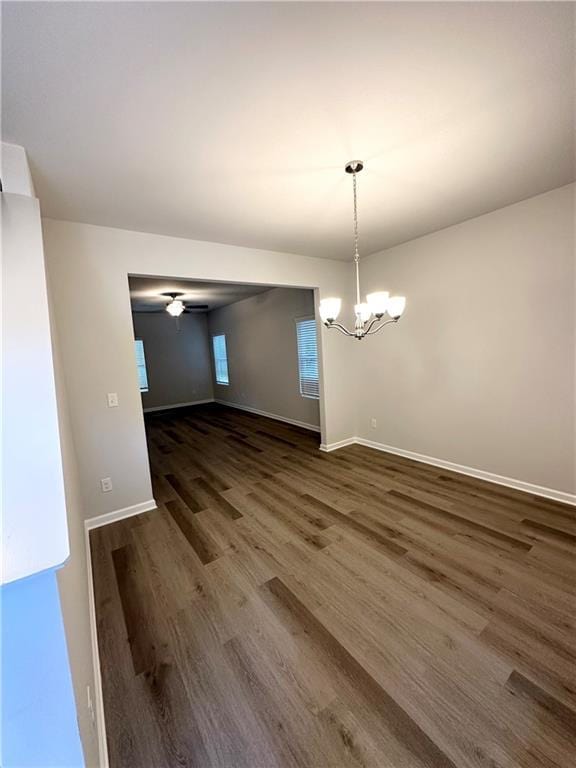 836 Courthouse Park Dr, Temple, GA 30179 - unfurnished dining area with dark wood-style flooring, a chandelier, and baseboards