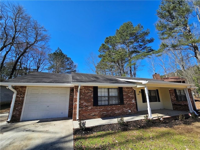 single story home featuring driveway, covered porch, a garage, brick siding, and a chimney