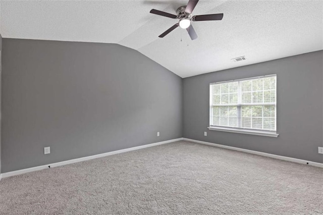 2183 Miranda Dr, Morrow, GA 30260 - carpeted empty room featuring a textured ceiling, vaulted ceiling, and ceiling fan
