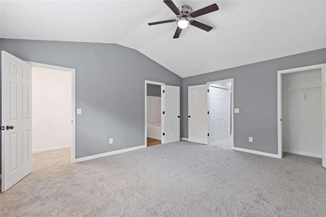 2183 Miranda Dr, Morrow, GA 30260 - unfurnished bedroom featuring lofted ceiling, carpet, a walk in closet, a closet, and ceiling fan