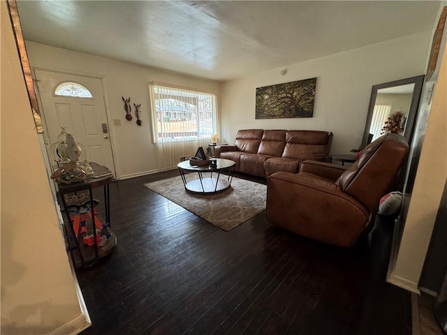 living area featuring hardwood / wood-style flooring and baseboards