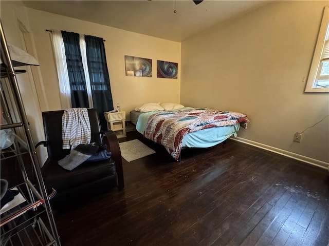 bedroom with baseboards and hardwood / wood-style floors