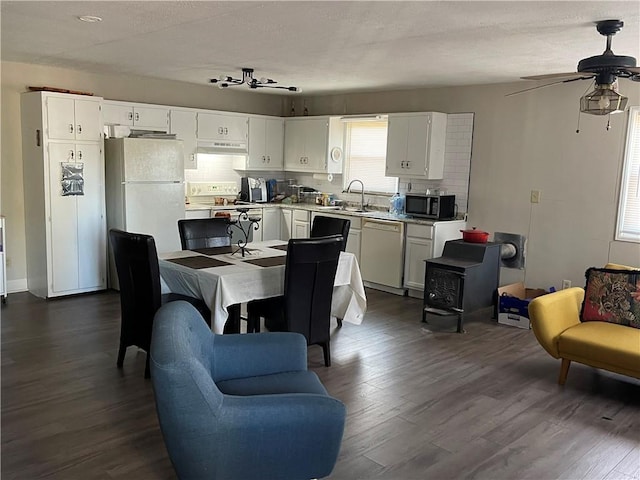 kitchen featuring ceiling fan, plenty of natural light, white appliances, and tasteful backsplash