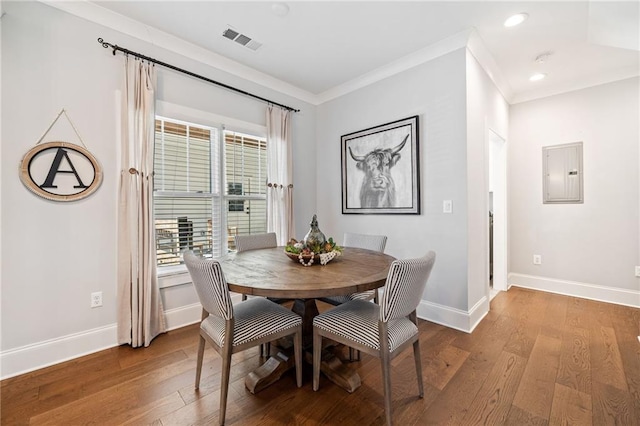 dining area featuring a wealth of natural light, electric panel, crown molding, and hardwood / wood-style floors