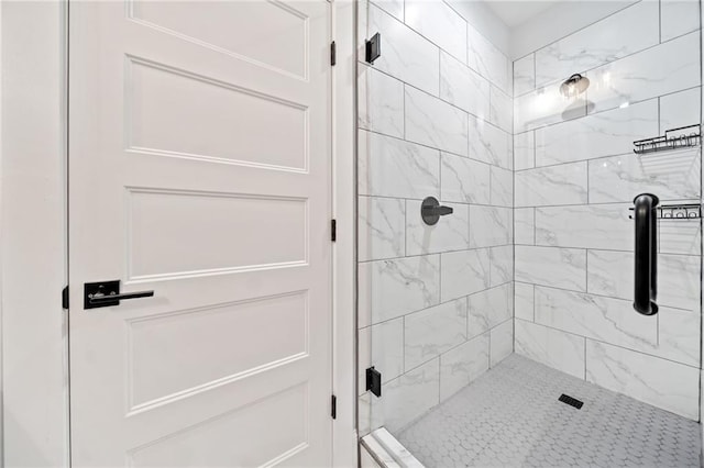 bathroom featuring a shower with door