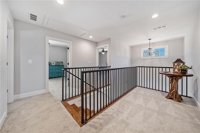 hallway with light colored carpet