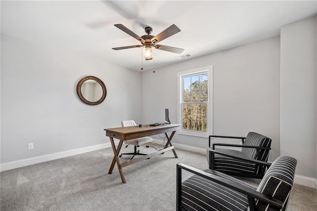 carpeted office space featuring ceiling fan