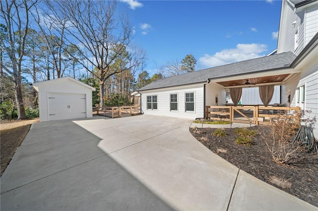 view of property exterior featuring a garage and an outdoor structure