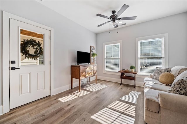 living room with ceiling fan and light hardwood / wood-style floors