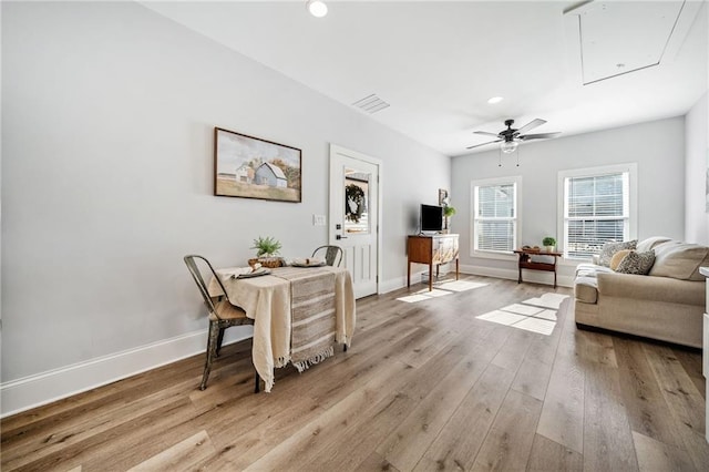 living room featuring ceiling fan and light wood-type flooring