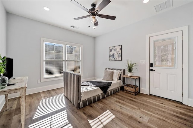 bedroom with ceiling fan and light hardwood / wood-style flooring