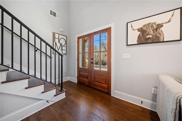 foyer with dark wood-type flooring and french doors