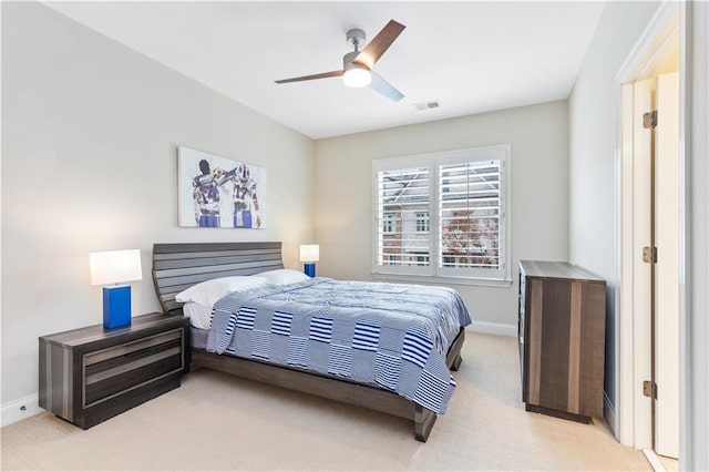 bedroom with ceiling fan and light carpet