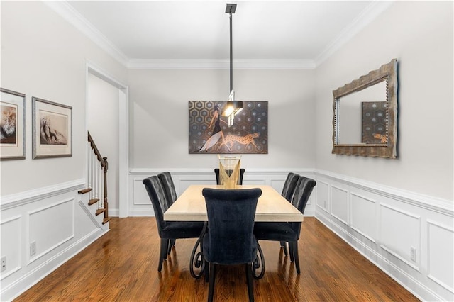 dining space featuring ornamental molding and dark hardwood / wood-style floors