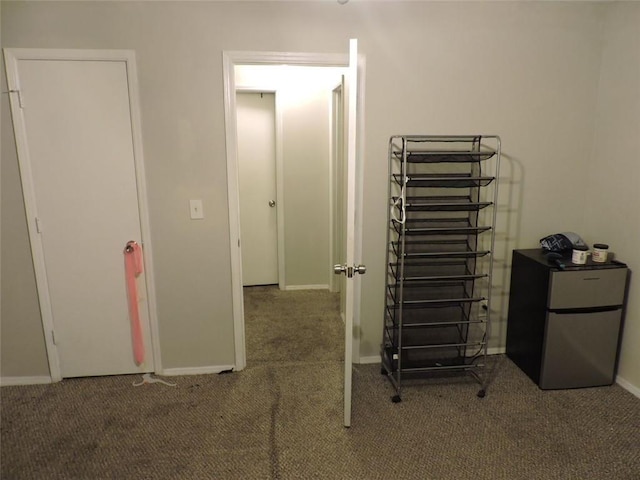 interior space with carpet floors and baseboards