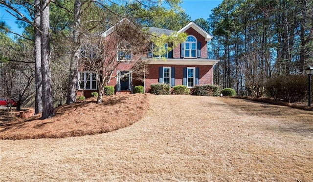 colonial inspired home with brick siding