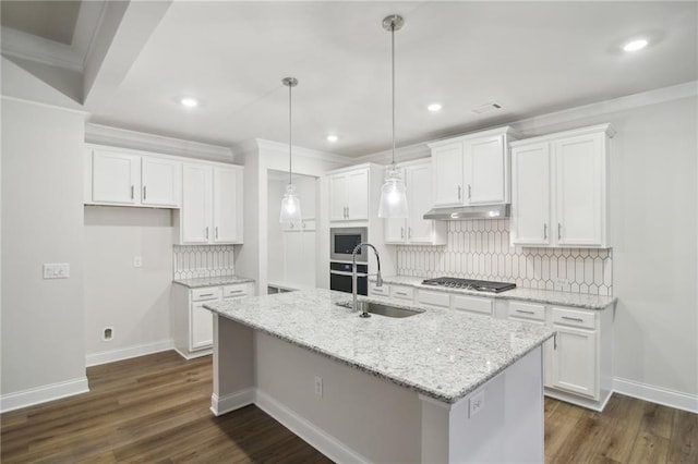 kitchen with white cabinetry, hanging light fixtures, a kitchen island with sink, and sink