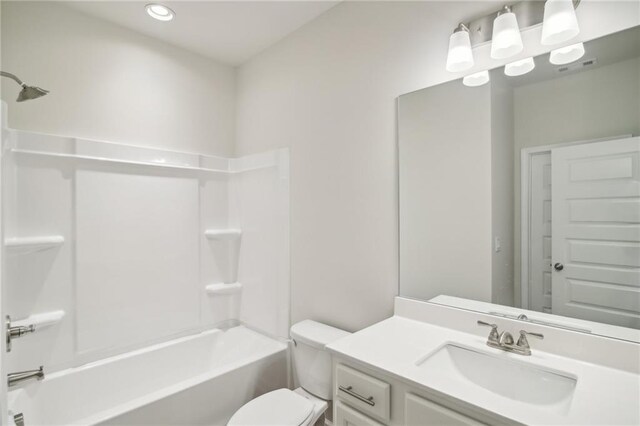 full bathroom with bathtub / shower combination, vanity, and toilet