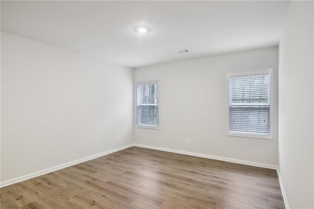 empty room featuring hardwood / wood-style floors and a healthy amount of sunlight