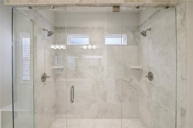 bathroom with a shower with shower door