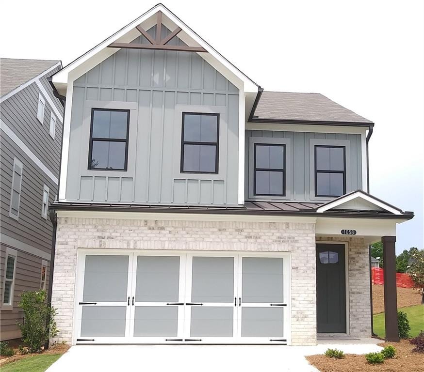 1058 Crest Mill Dr, Marietta, GA 30008 - view of front of property with board and batten siding, a garage, driveway, and roof with shingles