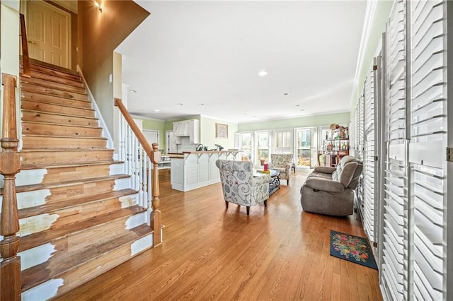 living room featuring light hardwood / wood-style floors and ornamental molding