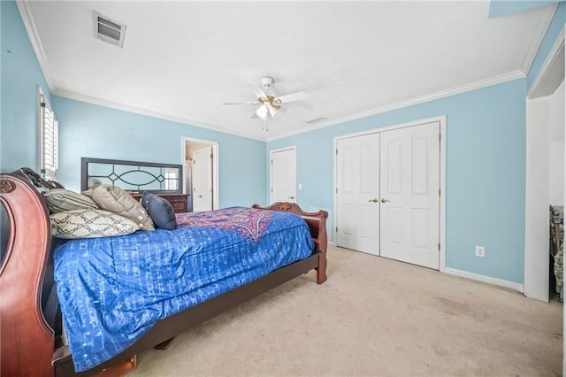 carpeted bedroom with ceiling fan, ornamental molding, and a closet