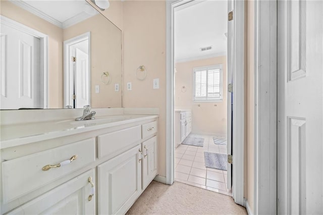 bathroom with tile patterned floors, vanity, and ornamental molding