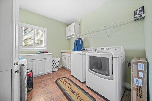 laundry room with cabinets, separate washer and dryer, and light tile patterned floors