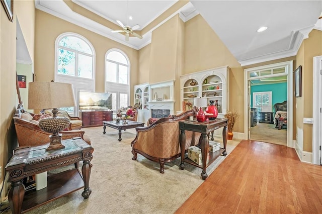 interior space with ceiling fan, hardwood / wood-style floors, and ornamental molding