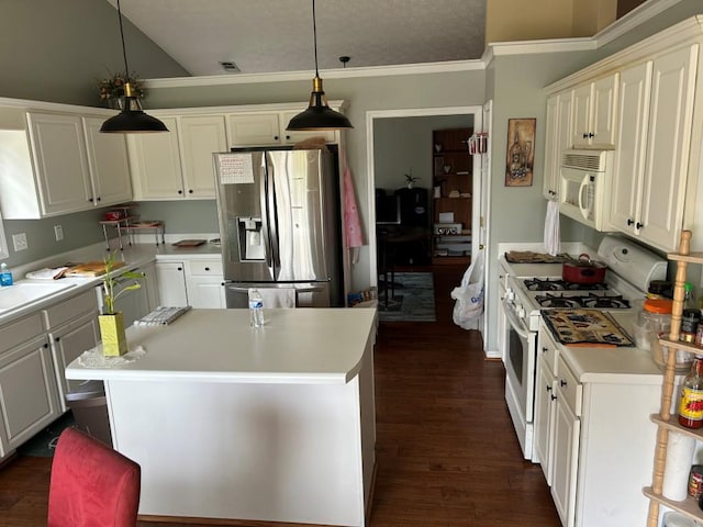 2256 Hansford Pass, Buford, GA 30519 - kitchen featuring white appliances, light countertops, dark wood-style floors, a kitchen island, and pendant lighting