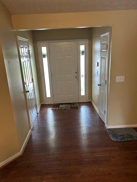 2256 Hansford Pass, Buford, GA 30519 - foyer with baseboards, dark wood finished floors, and a textured ceiling