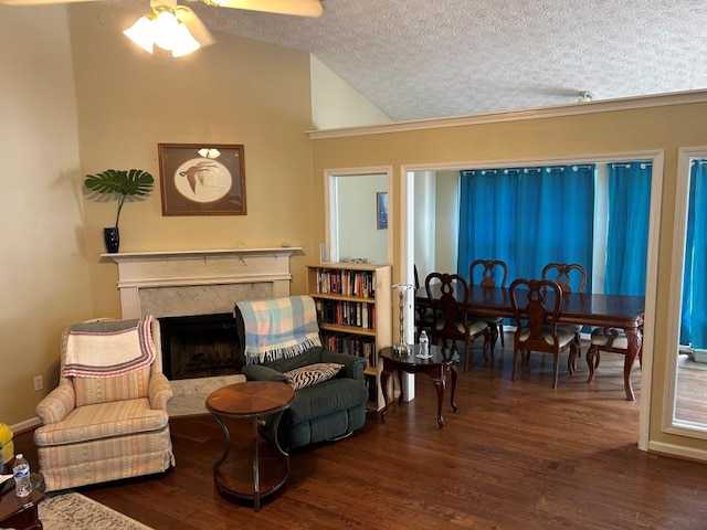 2256 Hansford Pass, Buford, GA 30519 - sitting room featuring wood finished floors, a ceiling fan, a textured ceiling, a high end fireplace, and vaulted ceiling