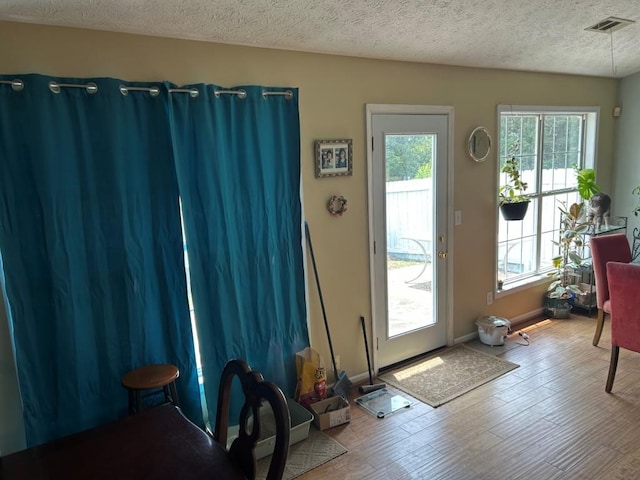 2256 Hansford Pass, Buford, GA 30519 - entryway featuring wood finished floors, a textured ceiling, and baseboards