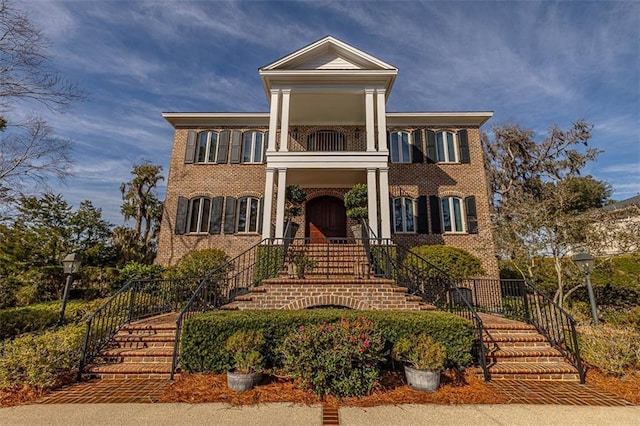 neoclassical home with a balcony