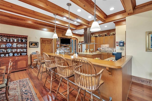 bar with hardwood / wood-style floors, tasteful backsplash, beamed ceiling, hanging light fixtures, and island exhaust hood