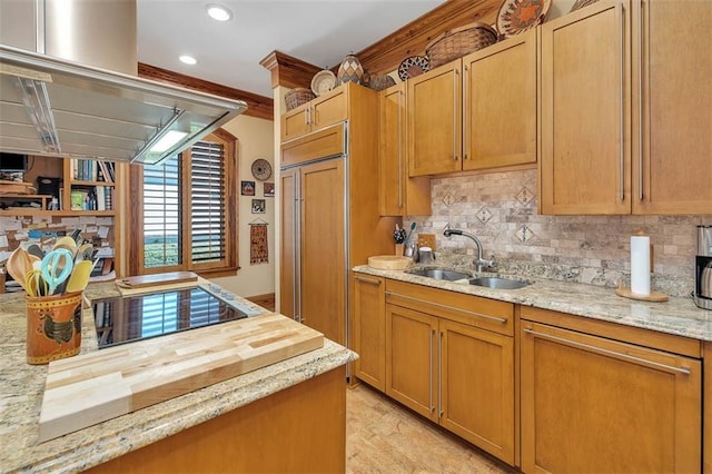 kitchen with sink, butcher block counters, decorative backsplash, paneled built in refrigerator, and black electric stovetop