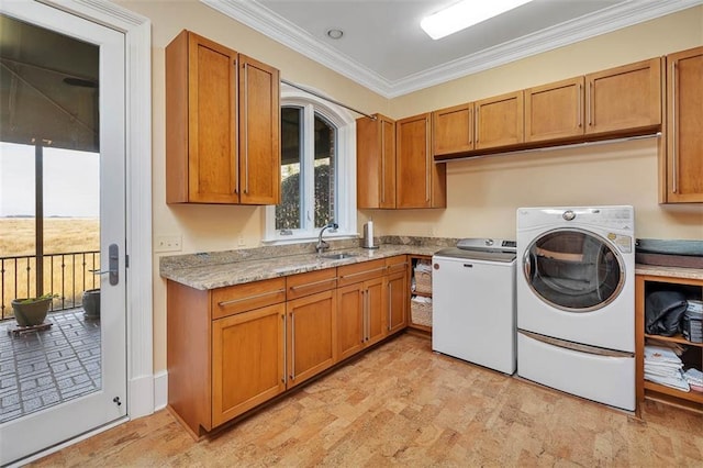 laundry area with separate washer and dryer, sink, crown molding, and cabinets