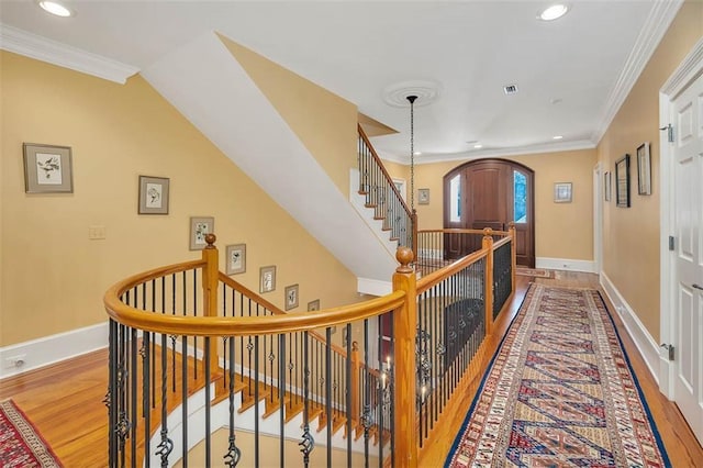 hallway featuring ornamental molding and hardwood / wood-style floors