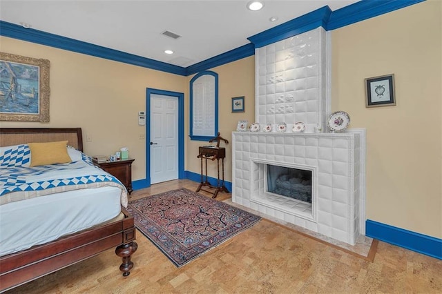 bedroom with ornamental molding and a fireplace