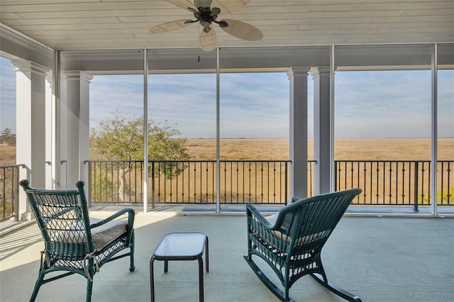 sunroom with a wealth of natural light and ceiling fan