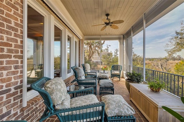 sunroom with wooden ceiling and ceiling fan