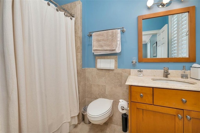 bathroom with tile walls, tile patterned flooring, a shower with shower curtain, vanity, and toilet