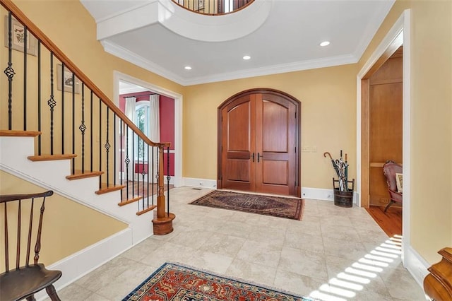 entryway featuring crown molding